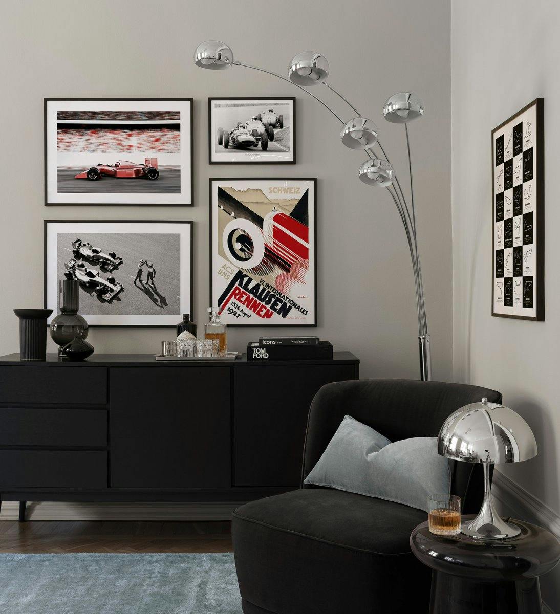 Race car gallery wall with photographs and illustrations of Formula 1 cars with black wood frames for the living room.
