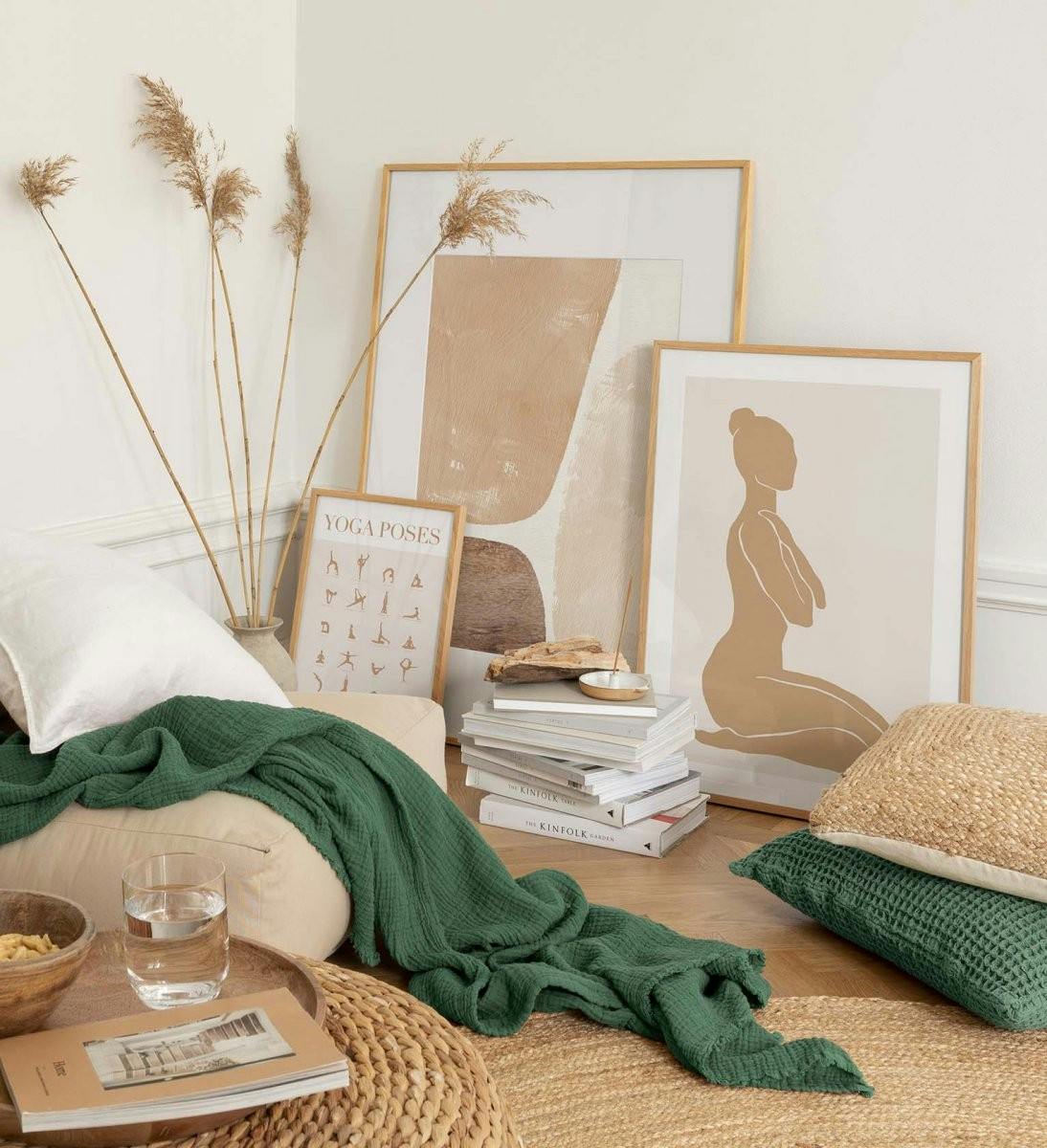 Clean and serene gallery wall with illustrations in beige with oak frames for living room