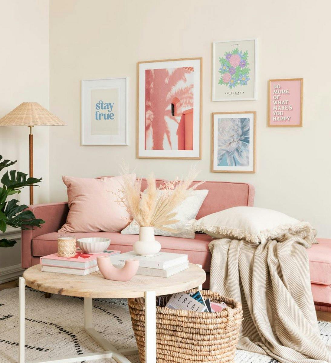 Gallery wall with soft pastels for the joyful living room. Frames in both oak and white wood. 