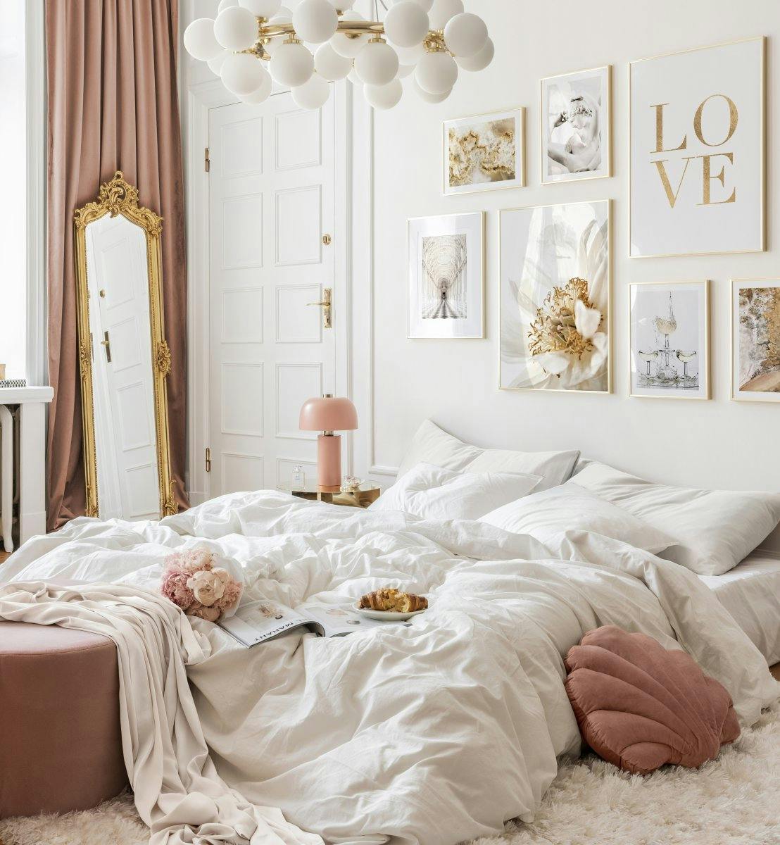 White and gold botanical posters and sparkling drink prints in romantic bedroom